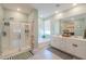 Bathroom showcasing a walk-in shower, soaking tub, double vanity, and neutral tones for a spa-like feel at 35175 W Marin Ave, Maricopa, AZ 85138