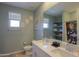 Modern bathroom with double sinks, granite countertops, and large mirror at 35175 W Marin Ave, Maricopa, AZ 85138