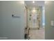 Bathroom space with a glass-enclosed shower, bathtub, and neutral color palette at 35175 W Marin Ave, Maricopa, AZ 85138