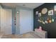 Bedroom with a crib, decorative wall hangings, and closet at 35175 W Marin Ave, Maricopa, AZ 85138