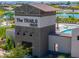 Community clubhouse with a pool and splash pad in a scenic neighborhood featuring a splash pad and pond at 35175 W Marin Ave, Maricopa, AZ 85138