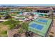 Aerial view of the community featuring a pool, playground, pickleball court, lake, and picnic area at 35175 W Marin Ave, Maricopa, AZ 85138