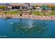 View of the community lake with a fountain, landscaping, and community amenities in the background at 35175 W Marin Ave, Maricopa, AZ 85138