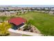 Community park with a covered picnic area, green space, landscaping, and walking paths at 35175 W Marin Ave, Maricopa, AZ 85138