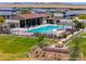 Community pool area with lounge chairs, tables, covered seating, and lush landscaping at 35175 W Marin Ave, Maricopa, AZ 85138