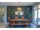 Cozy dining room featuring a large wooden table, bench seating, and decorative accents on a dark wall at 35175 W Marin Ave, Maricopa, AZ 85138