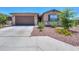 Charming home showcasing a two-car garage and xeriscaping with desert-friendly plants at 35175 W Marin Ave, Maricopa, AZ 85138