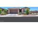 Charming single-story home featuring a two-car garage and desert landscaping at 35175 W Marin Ave, Maricopa, AZ 85138