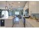 Spacious kitchen featuring an island with seating, stainless appliances, and an open flow to the living area at 35175 W Marin Ave, Maricopa, AZ 85138