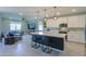 Open-concept kitchen featuring a large island with seating, white cabinets, and modern appliances at 35175 W Marin Ave, Maricopa, AZ 85138