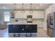 Bright kitchen with a large island, stainless appliances, and an open concept design for modern living at 35175 W Marin Ave, Maricopa, AZ 85138