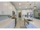 Bright kitchen with white cabinets, stainless steel appliances, and a spacious island with a farmhouse sink at 35175 W Marin Ave, Maricopa, AZ 85138