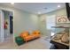 Bright living room showcasing an orange sofa, an ottoman, and a unique fish tank at 35175 W Marin Ave, Maricopa, AZ 85138