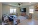 Comfortable living room with large gray sectional, ceiling fan, tv, and neutral color palette at 35175 W Marin Ave, Maricopa, AZ 85138
