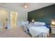 Bedroom featuring serene color scheme, soft carpet, and access to bathroom, walk in closet, and dressers at 35175 W Marin Ave, Maricopa, AZ 85138