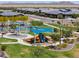 Community playground with slides, swings, covered picnic tables, and green space at 35175 W Marin Ave, Maricopa, AZ 85138