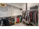 This walk-in closet features ample storage with hanging racks, shelving, and shoe racks at 35175 W Marin Ave, Maricopa, AZ 85138