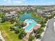 Aerial view of resort style community pool, lake, and luxury homes with immaculate landscaping at 4077 S Sabrina Dr # 30, Chandler, AZ 85248