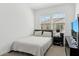 A bedroom with a queen bed by two windows, a nightstand, and a TV at 4077 S Sabrina Dr # 30, Chandler, AZ 85248
