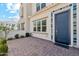 Close-up view of front door with blue trim, tile accents, and brick paved patio at 4077 S Sabrina Dr # 30, Chandler, AZ 85248