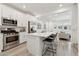 Beautiful kitchen with white cabinetry, stainless steel appliances, and an island open to the living area at 4077 S Sabrina Dr # 30, Chandler, AZ 85248