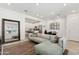 Open-concept living area with a modern sofa, stylish decor, and seamless flow to the kitchen at 4077 S Sabrina Dr # 30, Chandler, AZ 85248