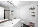 Bright bathroom featuring a large mirror, white cabinets, and decorative shelves on white walls at 4114 E Union Hills Dr # 1088, Phoenix, AZ 85050