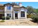 Charming two-story home with desert landscaping, a chimney, and a secure front door at 4114 E Union Hills Dr # 1088, Phoenix, AZ 85050