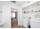Laundry room with modern appliances and shelving, located near the bedroom at 4114 E Union Hills Dr # 1088, Phoenix, AZ 85050