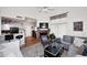 Open concept living room with a brick fireplace, a ceiling fan, and an adjacent kitchen at 4114 E Union Hills Dr # 1088, Phoenix, AZ 85050