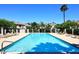 Community swimming pool surrounded by lounge chairs and lush landscaping at 4114 E Union Hills Dr # 1088, Phoenix, AZ 85050