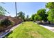 Expansive backyard with lush lawn, mature trees, and charming landscaping at 4335 E Enrose St, Mesa, AZ 85205