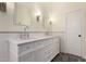 Bright bathroom featuring dual sinks, marble countertops, and modern lighting at 4335 E Enrose St, Mesa, AZ 85205