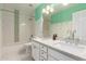 Well-lit bathroom boasting dual sinks, decorative accents, and a tub with shower at 4335 E Enrose St, Mesa, AZ 85205