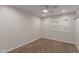 Neutral bedroom features include a ceiling fan and window with plantation shutters at 4335 E Enrose St, Mesa, AZ 85205