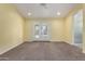 Spacious bedroom featuring neutral walls, carpet, and patio access at 4335 E Enrose St, Mesa, AZ 85205