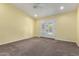 Spacious bedroom with neutral paint and carpet, a ceiling fan, and french doors to the backyard at 4335 E Enrose St, Mesa, AZ 85205