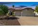 Charming home with a well-manicured front yard, spacious driveway and attached three-car garage at 4335 E Enrose St, Mesa, AZ 85205