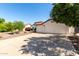 Charming home featuring a well-maintained lawn, two-car garage, and a warm, inviting facade at 4335 E Enrose St, Mesa, AZ 85205