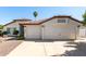 Charming home featuring a well-maintained lawn, two-car garage, and a warm, inviting facade at 4335 E Enrose St, Mesa, AZ 85205