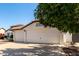 Charming home featuring a well-maintained lawn, two-car garage, and a warm, inviting facade at 4335 E Enrose St, Mesa, AZ 85205