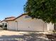 Spacious three-car garage with white doors and a tile roof, offering ample parking at 4335 E Enrose St, Mesa, AZ 85205