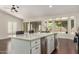 Kitchen island featuring a stainless steel dishwasher, ample cabinetry and a quartz countertop at 4335 E Enrose St, Mesa, AZ 85205