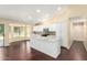 Well-lit kitchen featuring an island, modern appliances, and white cabinetry at 4335 E Enrose St, Mesa, AZ 85205