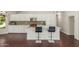 Open-concept kitchen with white cabinetry, modern appliances, and a spacious island with seating at 4335 E Enrose St, Mesa, AZ 85205