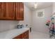 Functional laundry room with ample counter space, storage cabinets and tiled floors at 4335 E Enrose St, Mesa, AZ 85205
