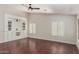 Stylish living room featuring hardwood floors, custom built-ins and plantation shutters at 4335 E Enrose St, Mesa, AZ 85205