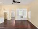Open concept living room featuring an entertainment center, ceiling fan, and rich wood floors at 4335 E Enrose St, Mesa, AZ 85205