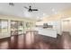 Open concept living space featuring an island kitchen, ceiling fan, and sliding doors to the patio at 4335 E Enrose St, Mesa, AZ 85205