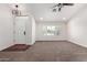 Bright living room featuring neutral walls, carpet flooring, a ceiling fan, and natural light at 4335 E Enrose St, Mesa, AZ 85205